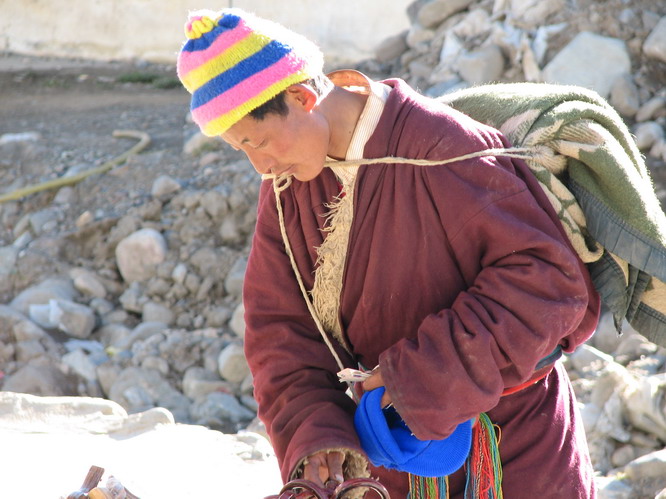 Tibetan pilgrim that came to walk the 56Km (33 miles) around Mt. Kailash. Tibetans do not take much with them when they do the walk. Mt. Kailash. Darchen, Tibet.